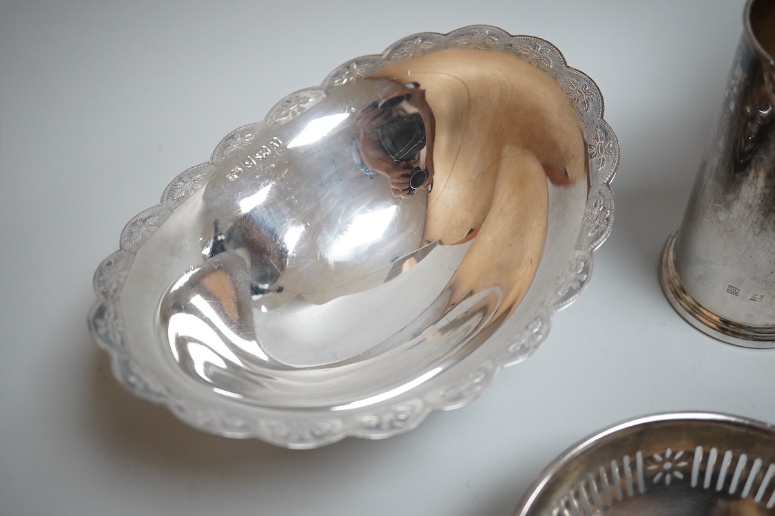 A modern silver oval pedestal sweetmeat bowl, by Mappin & Webb, Birmingham, 1987, 15.8cm, together with a small silver bottle holder, a silver mounted vase and a sterling two handled nut dish.